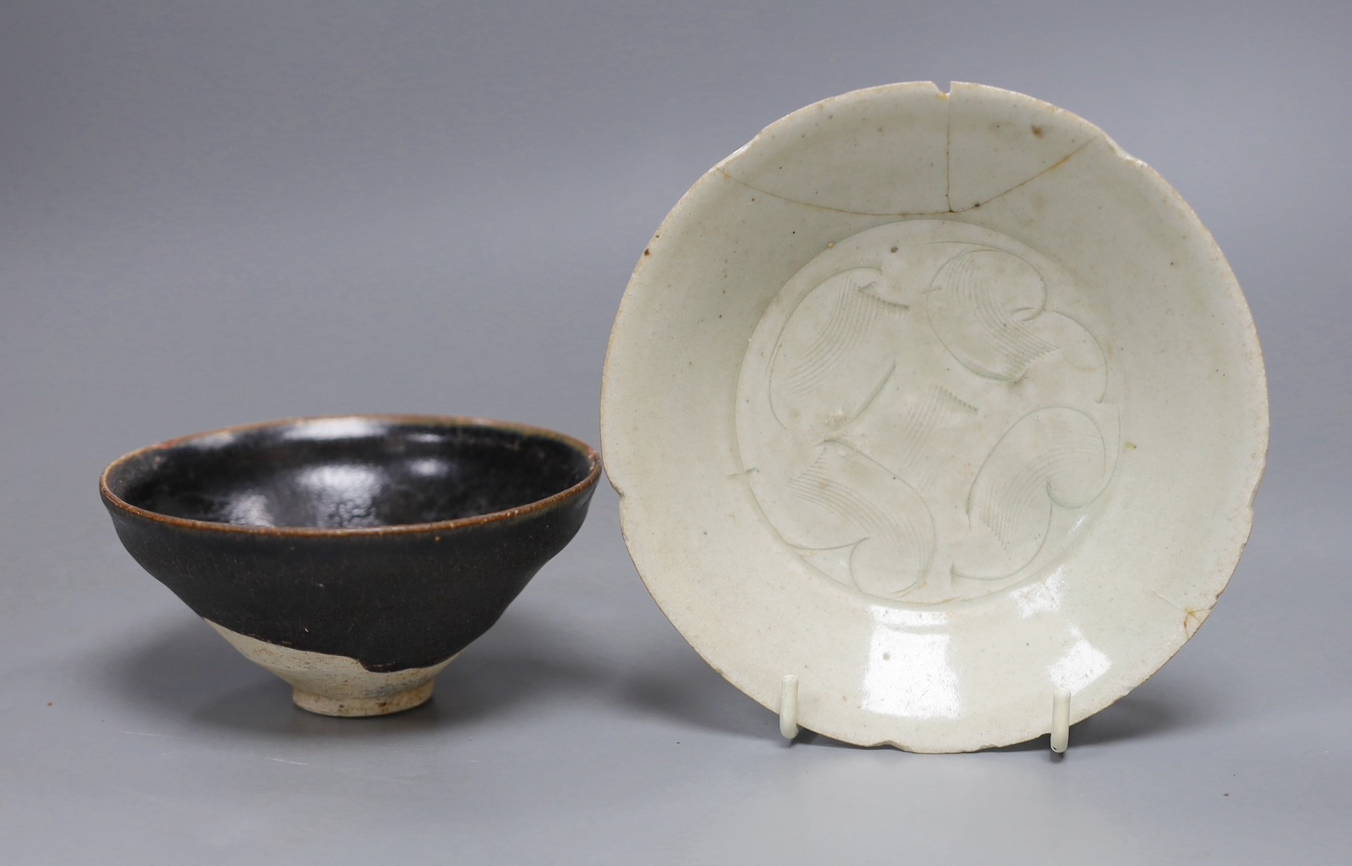 A Chinese Jizhou ‘scrolling leaf’ bowl, Song Dynasty, 11cm and a carved qingbai dish, 14cm